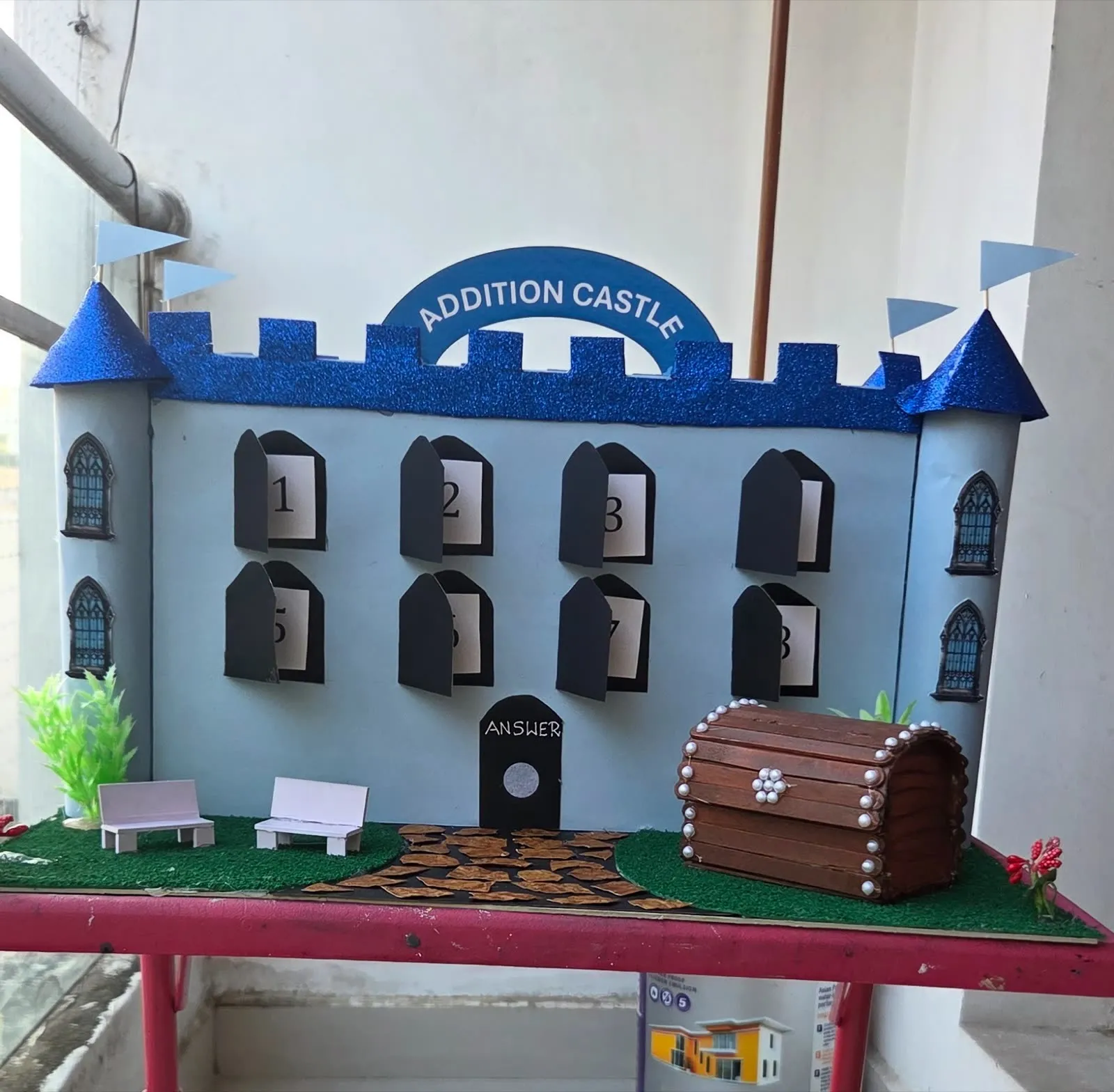 Addition Castle maths working model with numbered flap doors and coin treasure chest