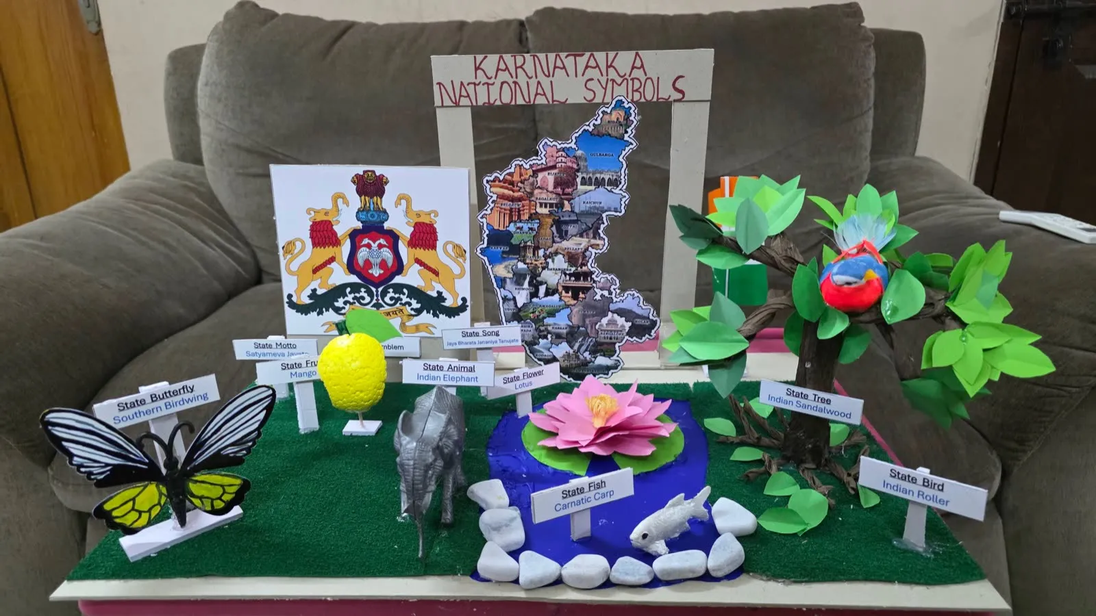Karnataka National Symbols display model with state emblem, elephant, lotus, butterfly and sandalwood tree